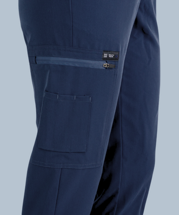 Navy blue jogger scrub pants with a zip-up pocket on the thigh